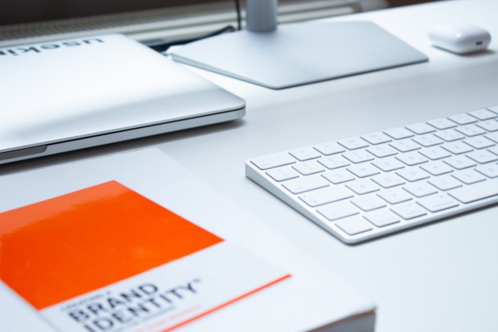 Brand identity book has pride of place on office desk.