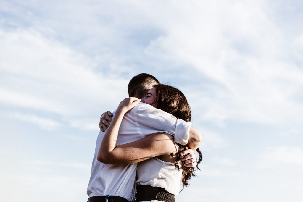 man and woman hugging